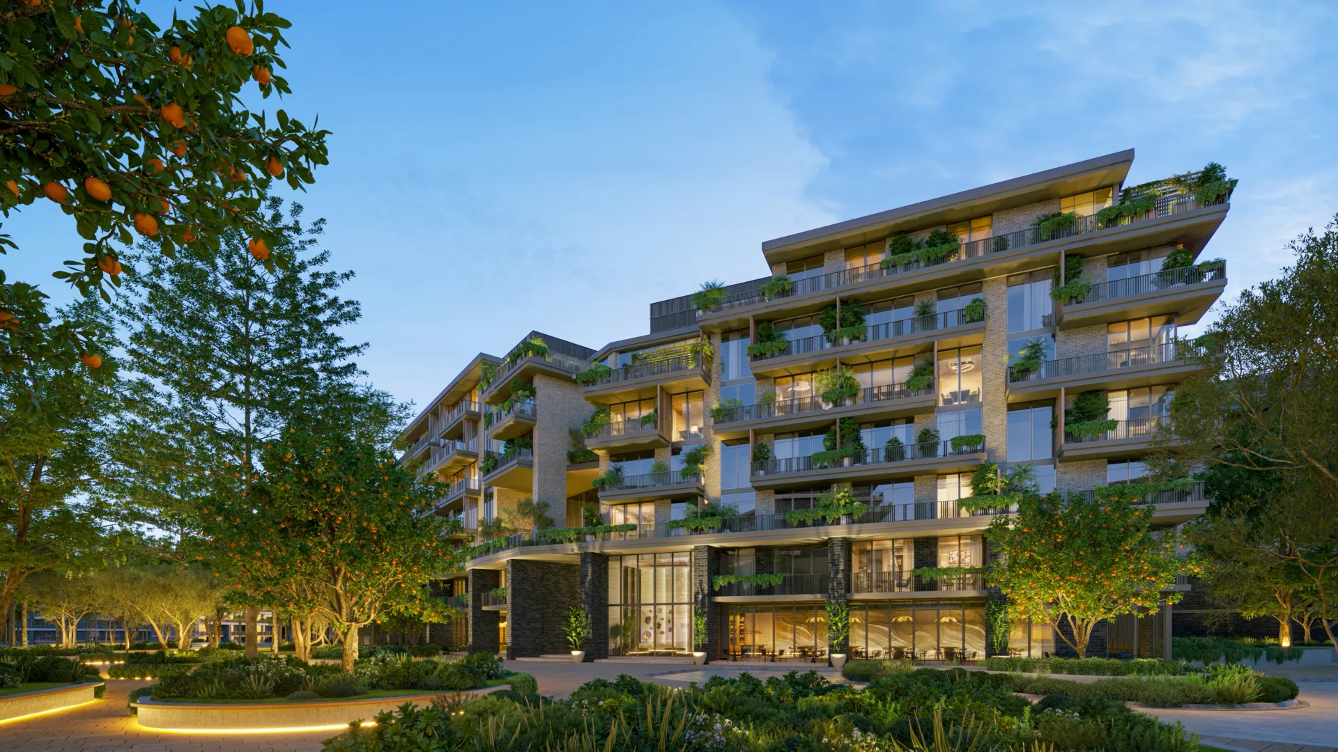 Low-rise apartment façades with planted balconies above a landscaped garden at Melograno Yards by Beyond