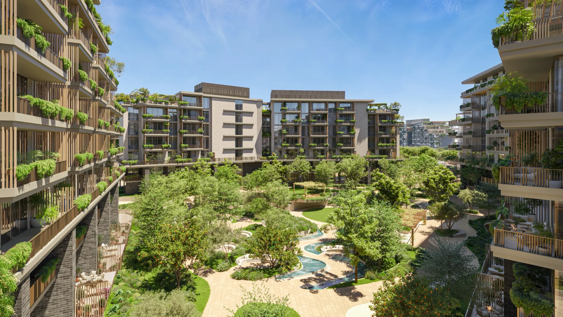 Apartment façades with planted balconies around a landscaped courtyard at Melograno Yards by Beyond