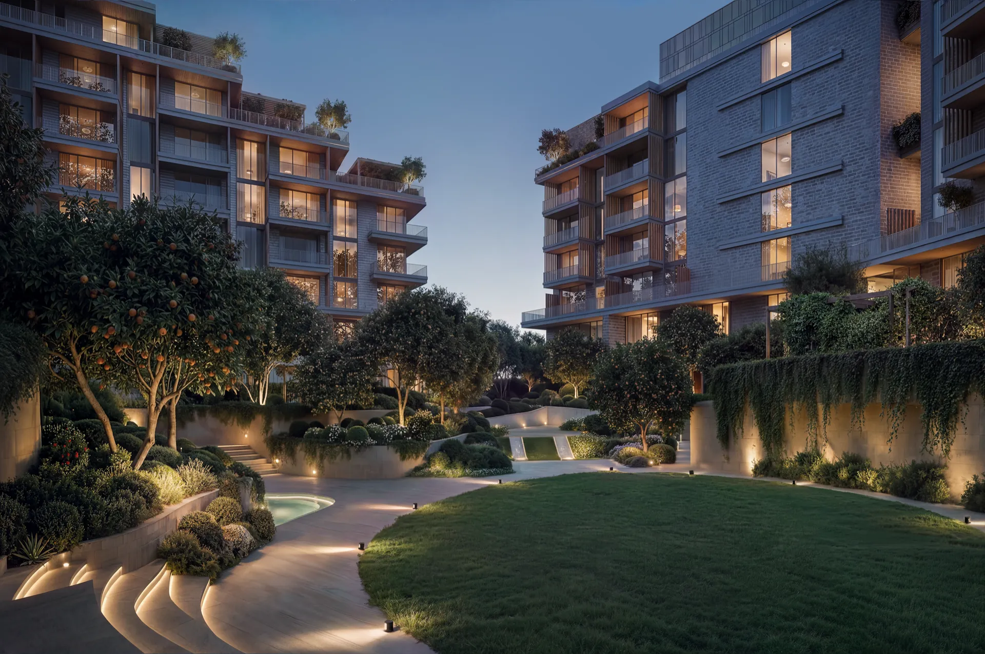 Sunken courtyard garden lit at night between the apartment buildings at Melograno Yards by Beyond